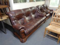 A three piece brown leather lounge suite with wooden frame