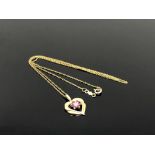 A 10ct gold ruby set heart pendant on chain