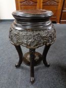 A circular Chinese style hardwood plant stand