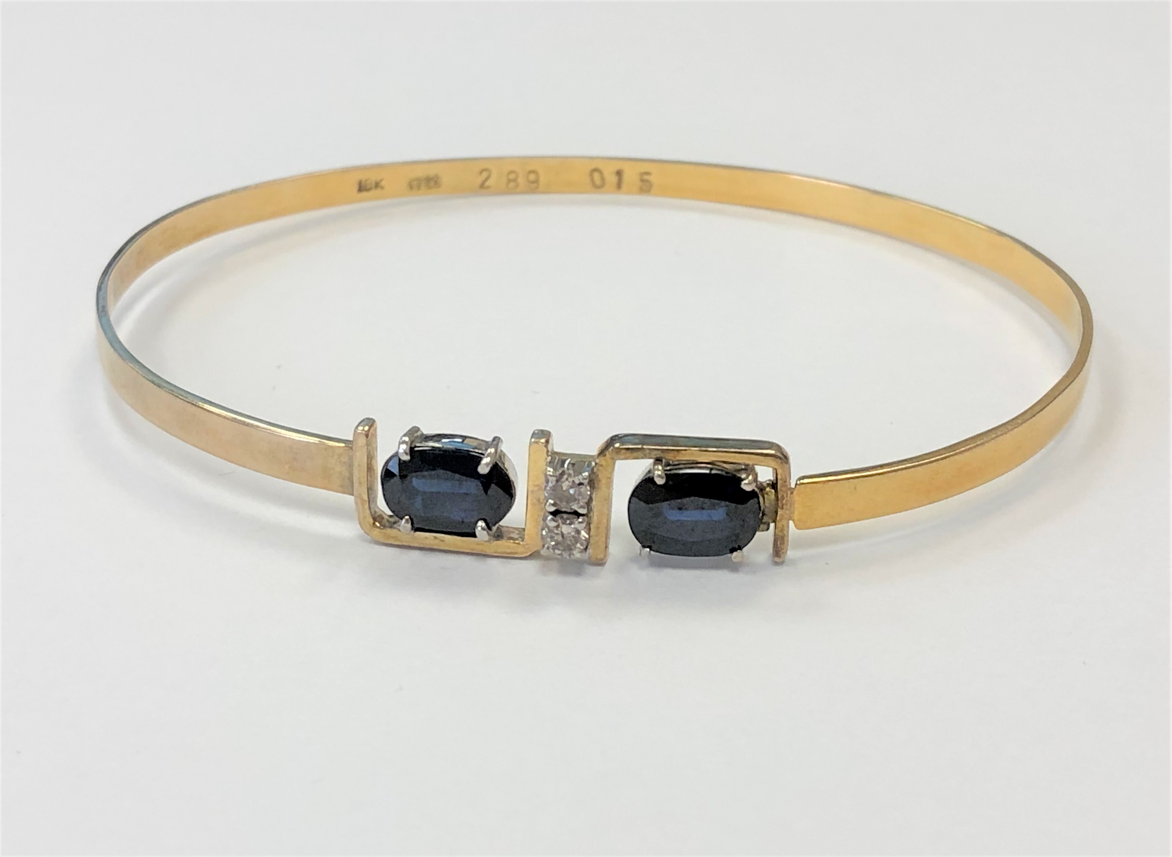 An 18ct gold sapphire and diamond bangle