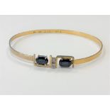 An 18ct gold sapphire and diamond bangle