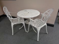 A painted aluminium patio table and two armchairs