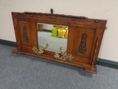 An Edwardian oak overmantel mirror with brass candle sconces