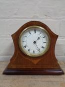 An early twentieth century Swiss made mantel clock on brass feet