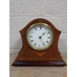 An early twentieth century Swiss made mantel clock on brass feet