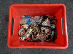 A plastic crate of costume jewellery