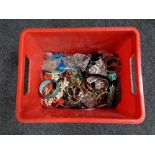 A plastic crate of costume jewellery