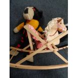 A mid century rocking horse with two soft toys