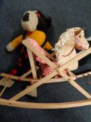 A mid century rocking horse with two soft toys