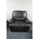 A brown leather electric reclining armchair