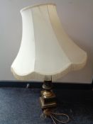 A brass table lamp with tasseled shade