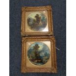 A pair of antiquarian gilt framed oil paintings - figures by a river with dwellings beyond (2)