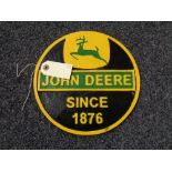 A metal John Deere plaque