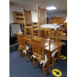 A pine kitchen table and six high backed chairs