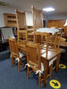 A pine kitchen table and six high backed chairs