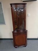 An inlaid mahogany corner display cabinet