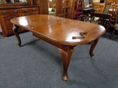 A Victorian mahogany wind out dining table with two leaves