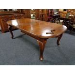 A Victorian mahogany wind out dining table with two leaves