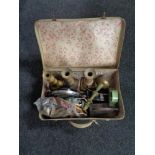 A vintage luggage case of antique iron, brass candlesticks, mid century mantel clock,
