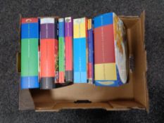 A box of seven Harry Potter hardback and paper backed volumes