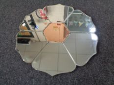 A frameless Art Deco two tone mirror in the form of a flower, 60 cm wide.