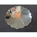 A frameless Art Deco two tone mirror in the form of a flower, 60 cm wide.