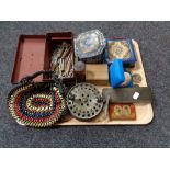 A tray of vintage cash box and tins, beaded purse, bullet casings, costume jewellery,