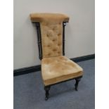 An antique ebonised prayer chair