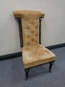 An antique ebonised prayer chair