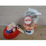 Two metal Coca Cola money boxes