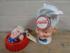 Two metal Coca Cola money boxes