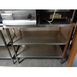 A stainless steel three tier prep table