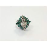 An 18ct gold emerald and diamond cluster ring,