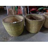 A pair of stone barrel planters
