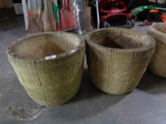 A pair of stone barrel planters