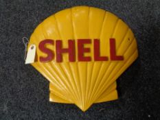 A metal Shell logo plaque