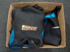 A box of three wet suits size medium