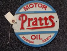 A metal Pratts Motor oil plaque