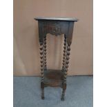 An Edwardian oak barley twist plant stand