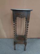 An Edwardian oak barley twist plant stand