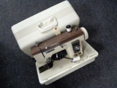 A Newholme electric sewing machine in case
