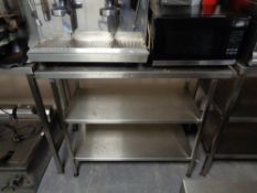 A stainless steel three tier prep table