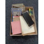 A box of vintage postcards, British Crowns, Hip flask, stamp album and stamps,