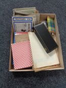 A box of vintage postcards, British Crowns, Hip flask, stamp album and stamps,