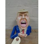 A metal novelty money box - Donald Trump