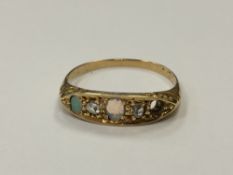 An 18ct gold opal and diamond ring (one opal deficient), size N. CONDITION REPORT: 2.