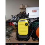 A Karcher pressure washer with accessories