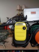 A Karcher pressure washer with accessories