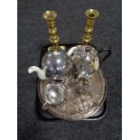 A tray of heavy brass candlesticks, two plated serving trays,