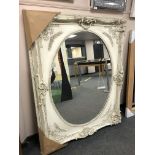 A large white oval panel mirror